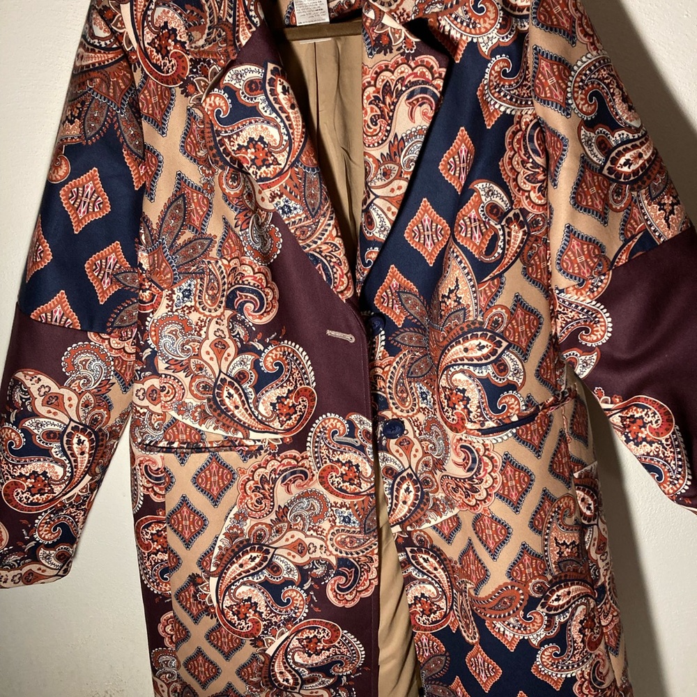 Woman’s Chico Brown and Navy Paisley print above the knee coat.